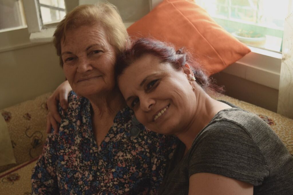 Accueil A heartwarming moment shared between two women, radiating love and joy indoors.